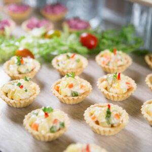 Delicious tartlets stuffed with vegetable salad